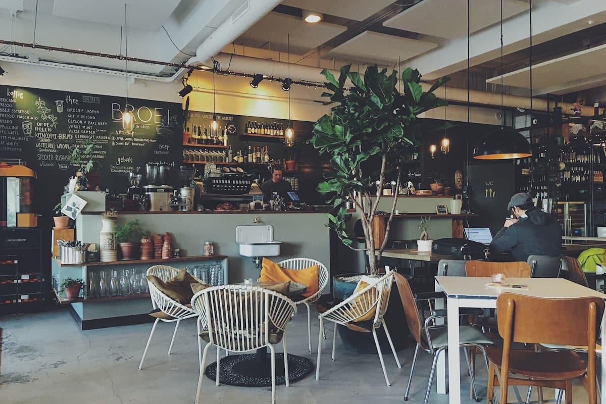 A coffee being made at a café counter