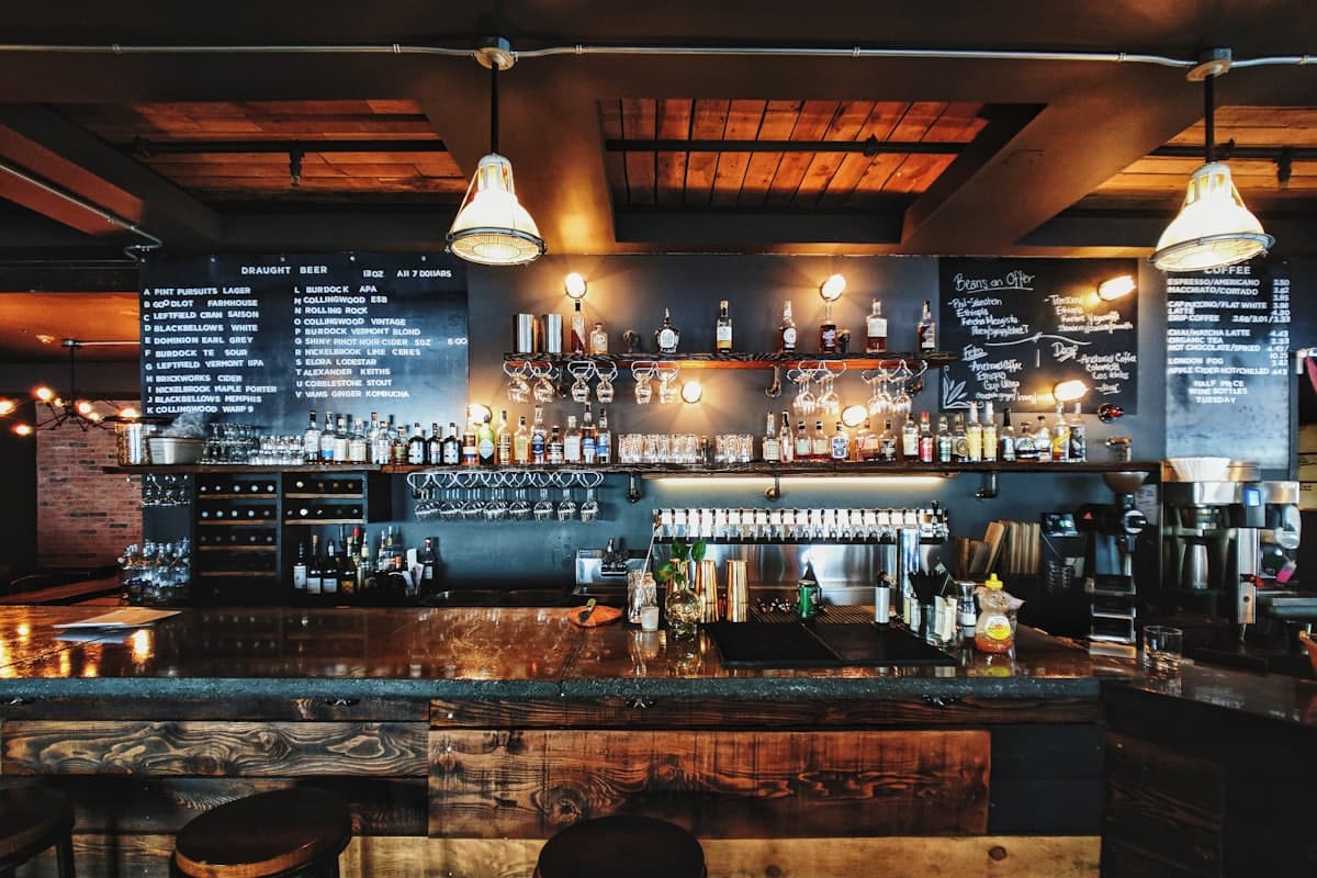 Bottles and taps behind a busy bar
